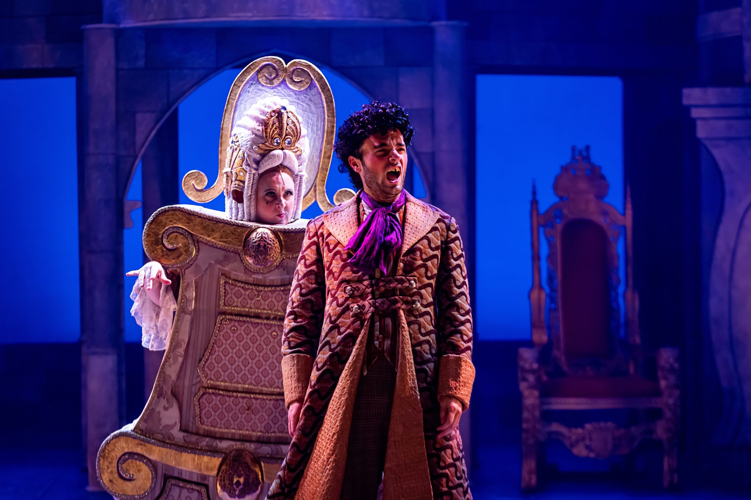 Musical Theatre Coach, Kristal Seid as the Wardrobe in Casa Manana’s “Beauty and the Beast,” standing center stage in an ornate costume resembling a wooden armoire, with a regal set design in the background.