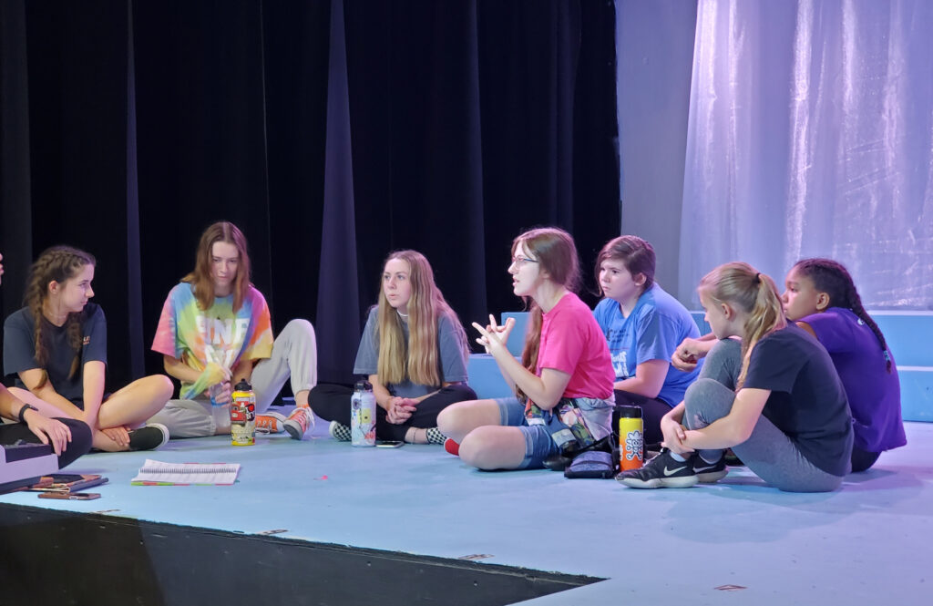 Kristal Seid directing a rehearsal for “Elf,” showcasing her expertise in musical theatre.